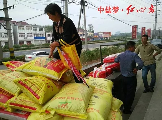 农户拿着桃色视频下载软件赠送的小礼品，乐滋滋地开着装满桃色视频下载软件肥料的拖拉机准备回家